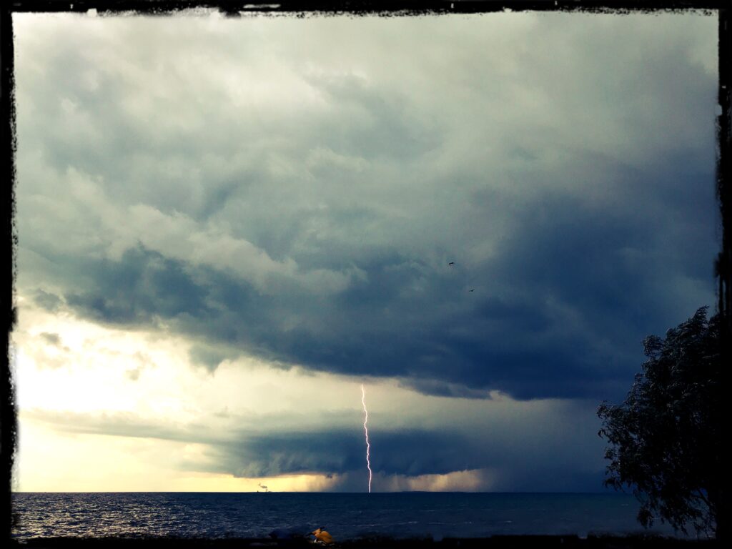 storm sky with lightening over lake